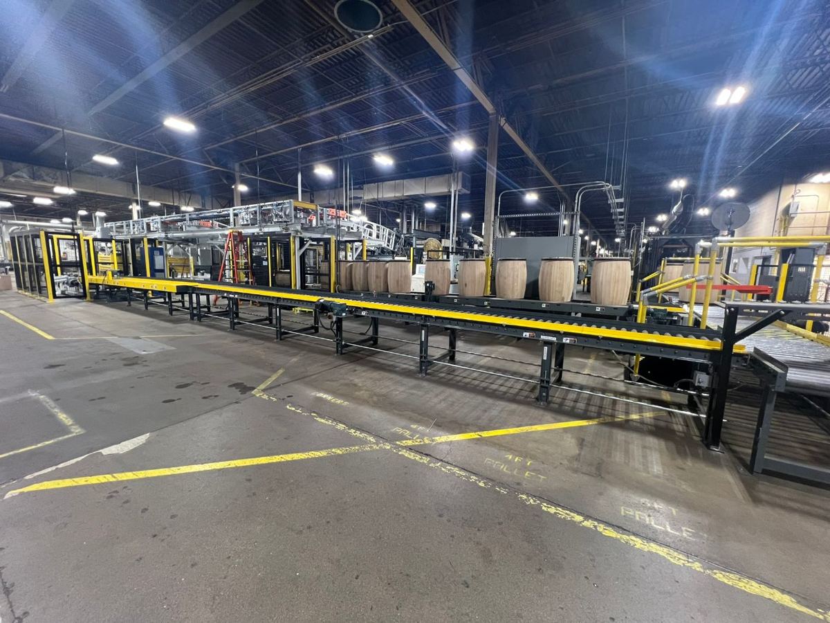 Barrel accumulation conveyor and down ender