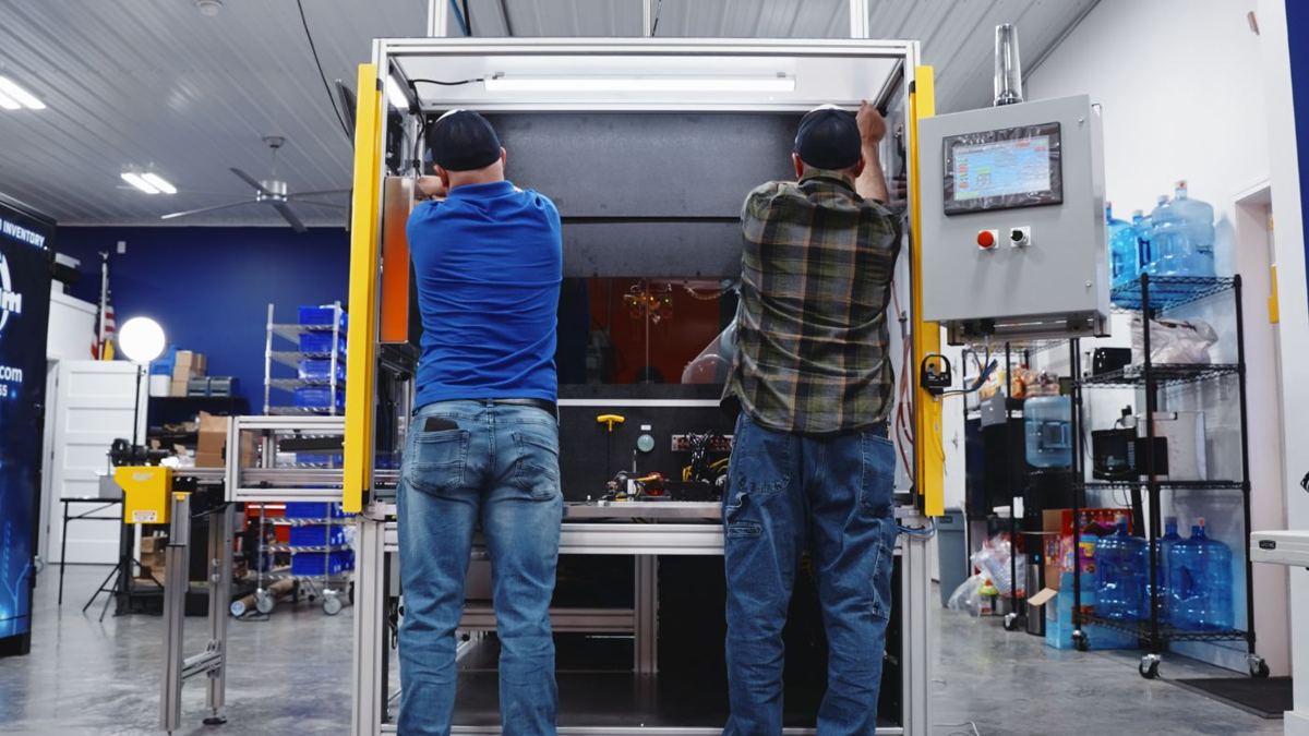 Team assembling a leak test machine